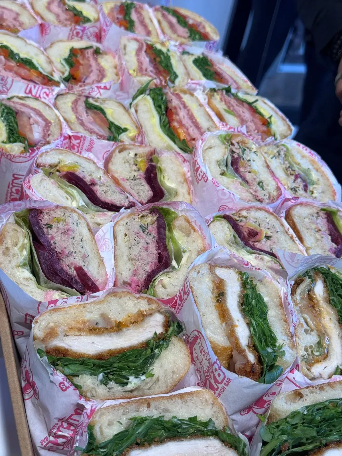Tray of wrapped sandwiches
